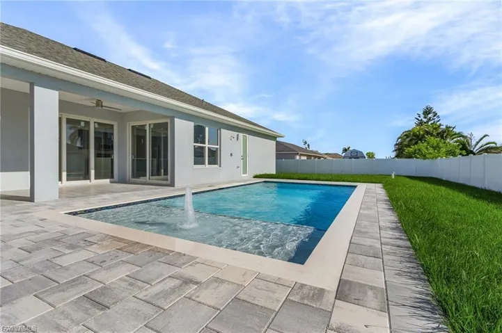 View of swimming pool with a patio and a fenced backyard