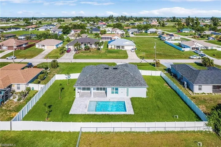 Aerial perspective of suburban area with a pool