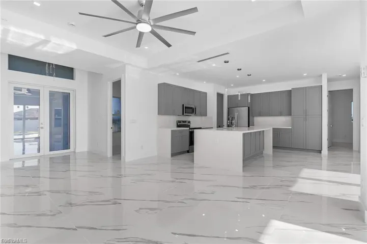 Unfurnished living room featuring light marble finish floors, recessed lighting, and ceiling fan