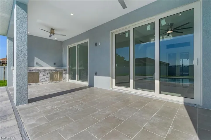 View of patio / terrace featuring a ceiling fan and exterior kitchen