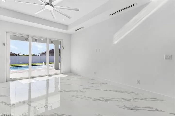 Spare room featuring light marble finish floors, a ceiling fan, and recessed lighting