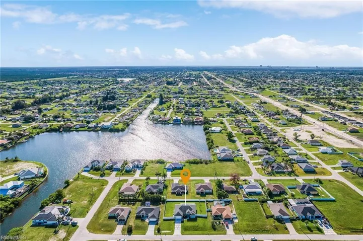 Aerial perspective of suburban area with a large body of water