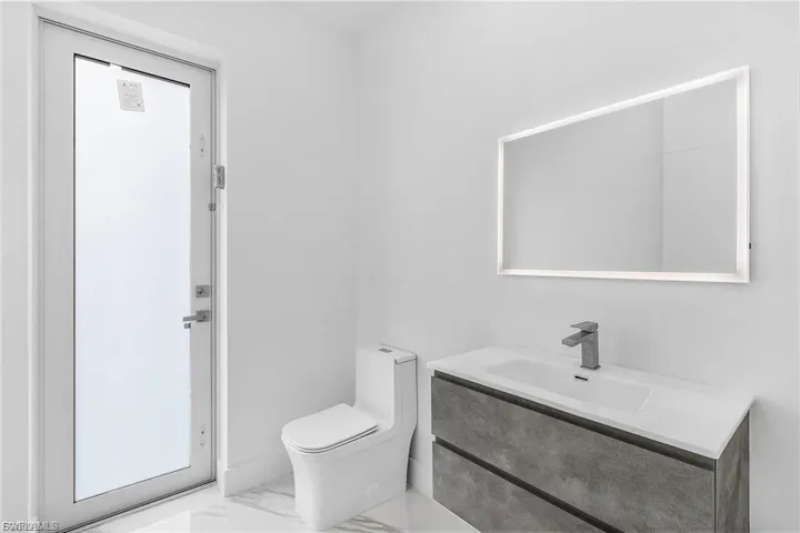 Bathroom featuring marble finish floors and vanity