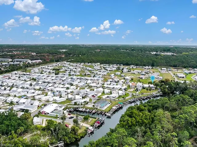 Aerial view of property and surrounding area featuring a large body of water