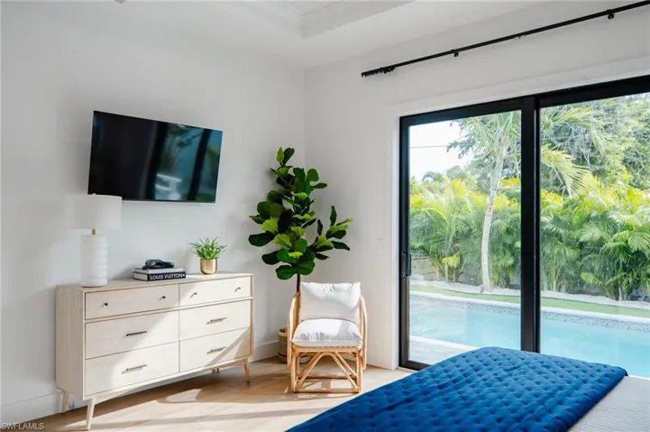 Primary suite view of pool & tropical landscape