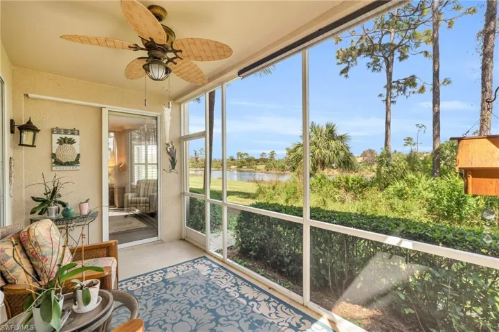 Sunroom / solarium featuring a water view and ceiling fan