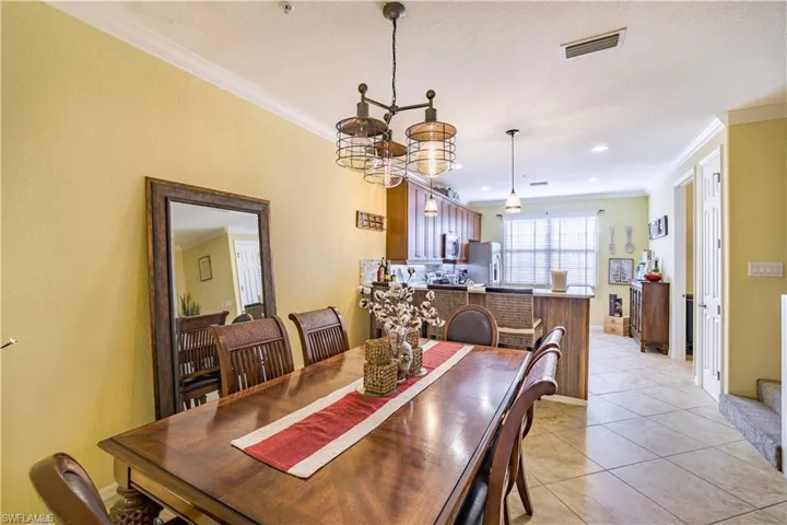 Dining area featuring a contemporary chandelier and crown molding