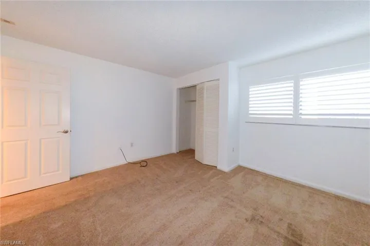 Second bedroom with  carpet and a closet