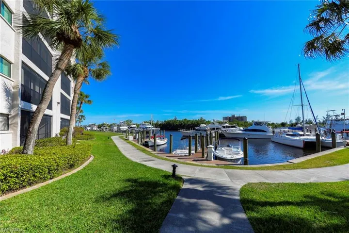 Dock area with a lawn and a water view