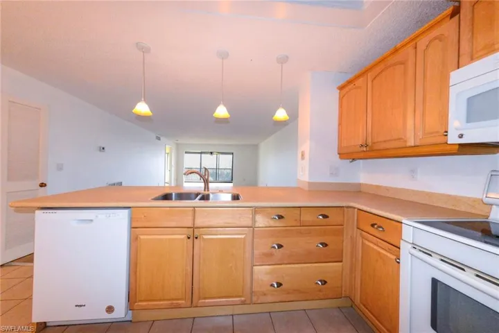 Kitchen featuring sink, pendant lighting, and views out to the bay