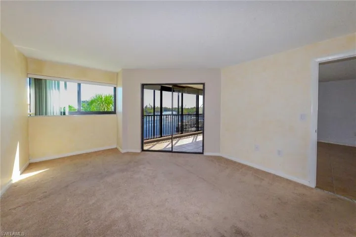 Primary bedroom with a healthy amount of sunlight and carpet