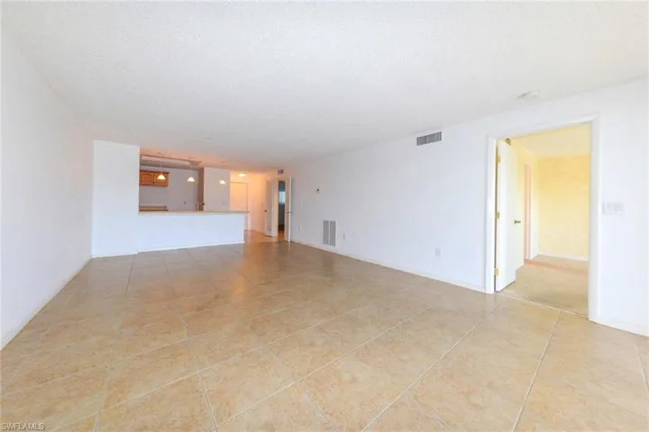 Living room featuring light tile patterned floors and a textured ceiling