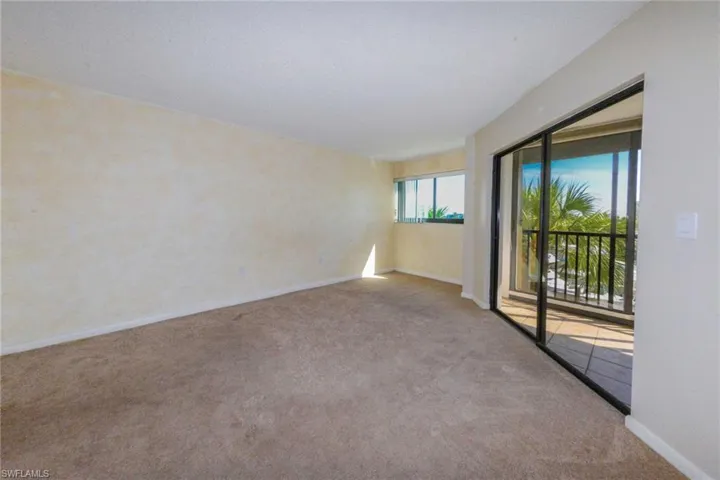 Unfurnished room featuring light carpet