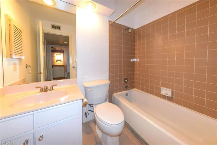 Full bathroom with vanity, tile patterned flooring, tiled shower / bath combo