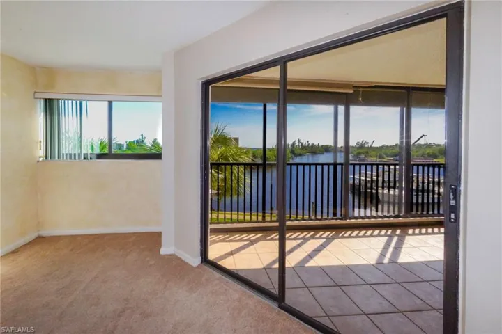 Carpeted room with a water view