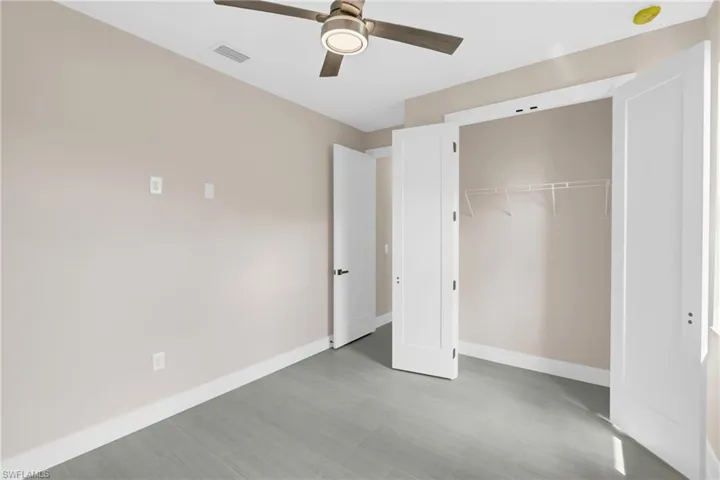 Unfurnished bedroom with a closet and a ceiling fan