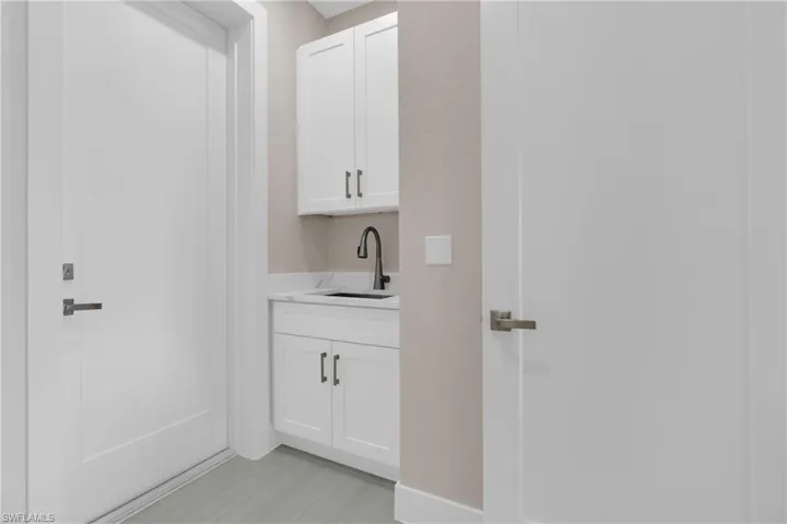 Laundry area featuring a sink and baseboards