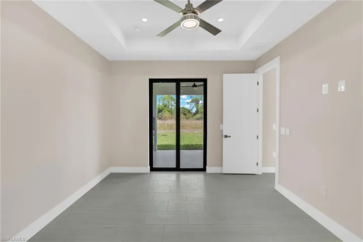 Spare room featuring ceiling fan, a tray ceiling, and recessed lighting