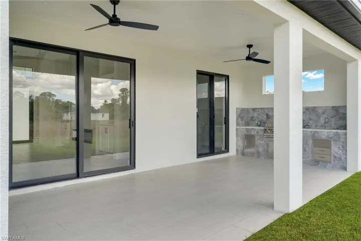 View of patio / terrace featuring area for grilling and a ceiling fan