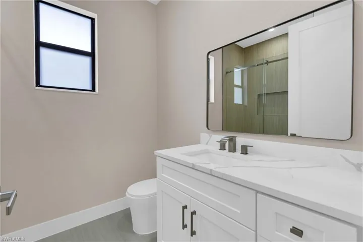 Full bathroom featuring vanity and a shower stall