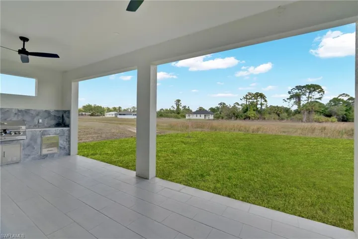 View of patio with a ceiling fan and an outdoor kitchen