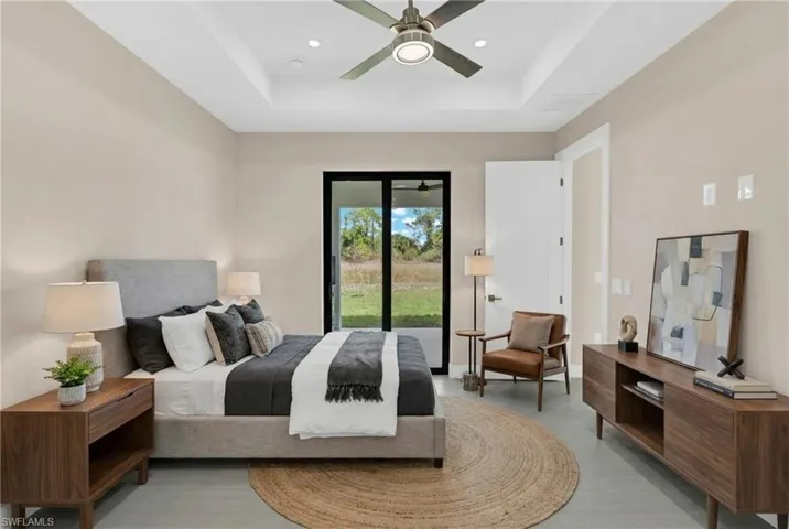 Virtually Staged-Bedroom featuring a raised ceiling, ceiling fan, access to exterior, and recessed lighting