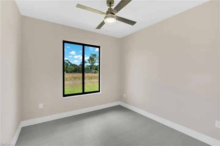 Unfurnished room featuring a ceiling fan and light wood-style flooring