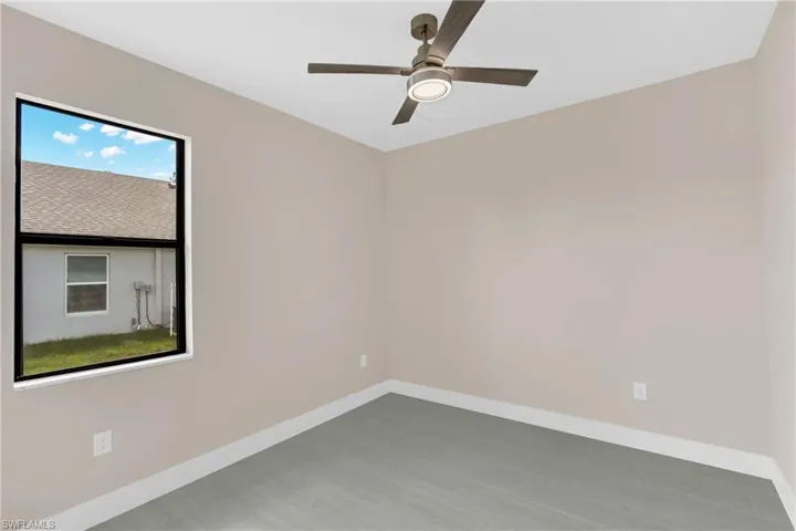 Empty room featuring ceiling fan and light wood-style flooring