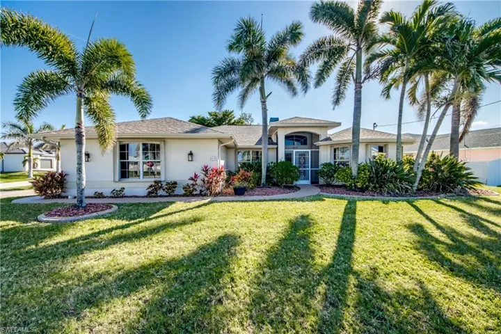 Ranch-style home featuring a front yard