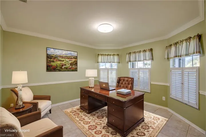 Office space featuring crown molding and light tile patterned floors