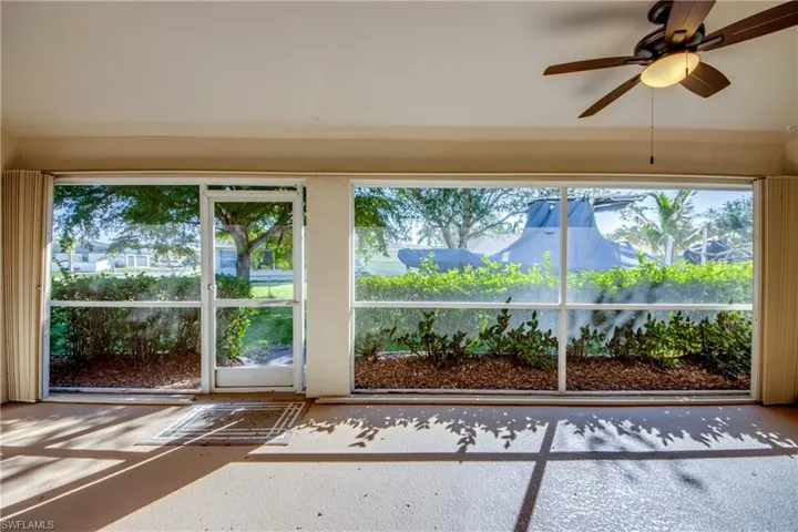 Unfurnished sunroom featuring ceiling fan