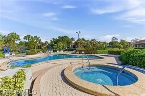 Outdoor amenity area featuring a curvilinear swimming pool and an integrated spa