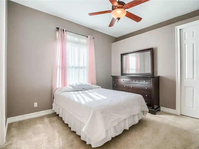 Bedroom featuring ceiling fan and light colored carpet