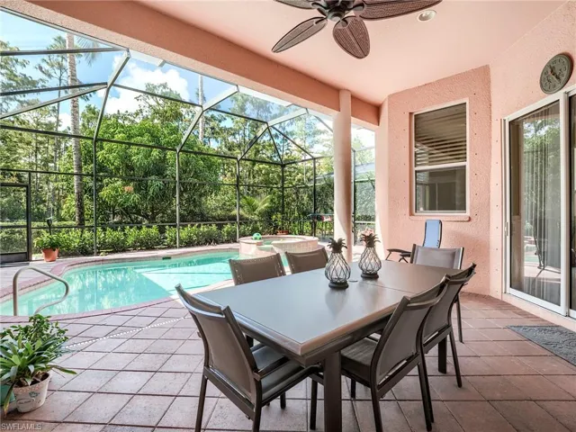 View of swimming pool with a lanai, an in ground hot tub, a patio, and ceiling fan
