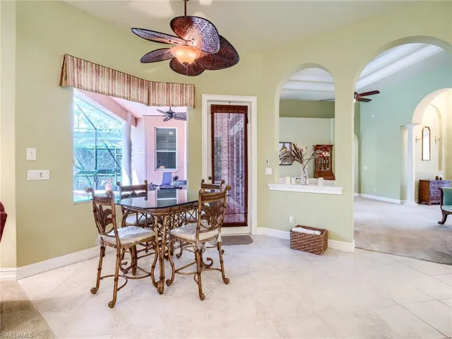 Dining room featuring ceiling fan and light carpet