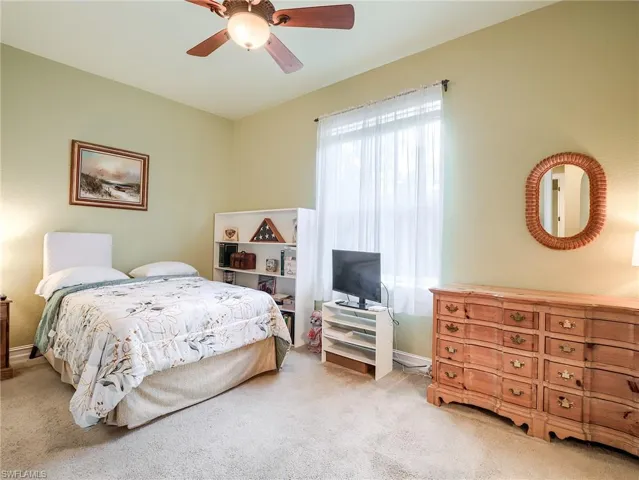 Carpeted bedroom with ceiling fan
