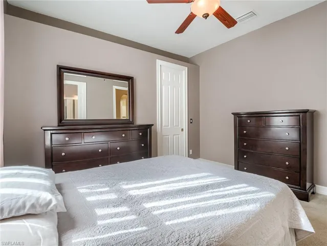 Bedroom featuring ceiling fan and light colored carpet