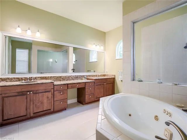 Bathroom with vanity, shower with separate bathtub, and tile patterned flooring