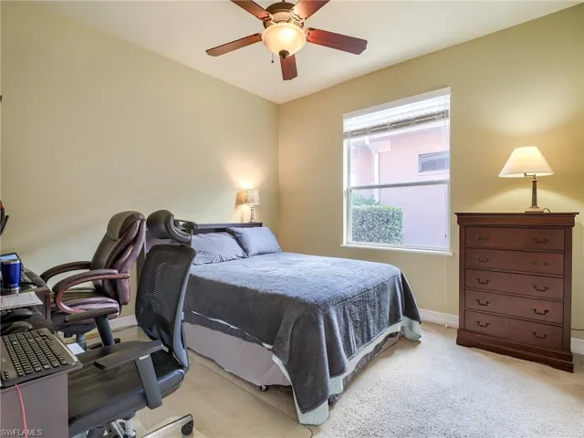 Bedroom featuring light carpet and ceiling fan