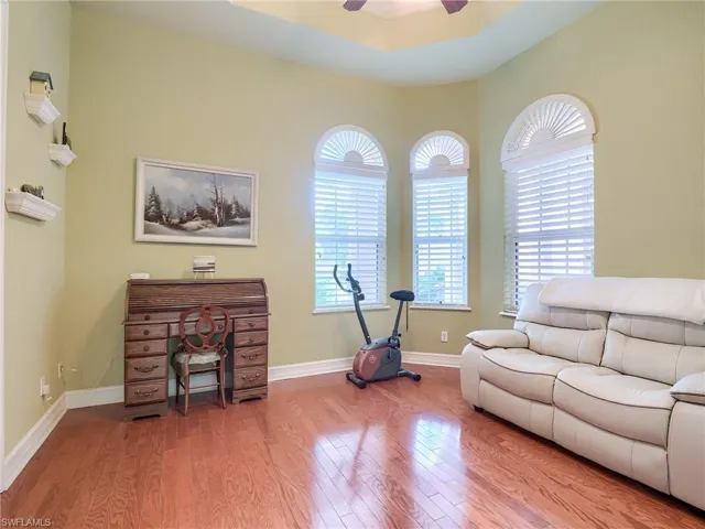 Living room featuring ceiling fan and light hardwood / wood-style flooring