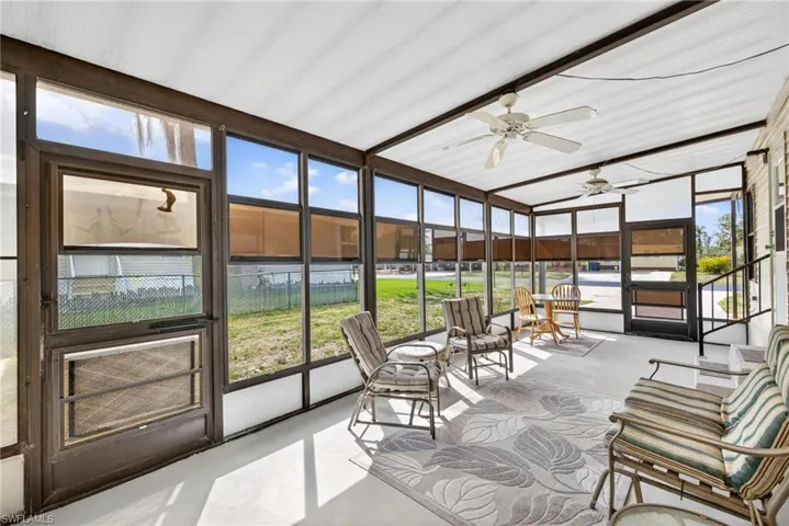 The property features a spacious screened-in lanai with a ceiling fan, offering views of the surrounding outdoor area