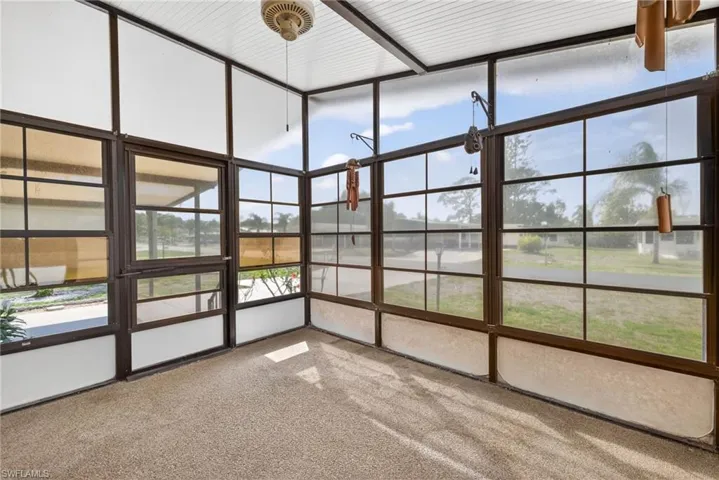 The enclosed patio features large windows providing views of the outdoor space