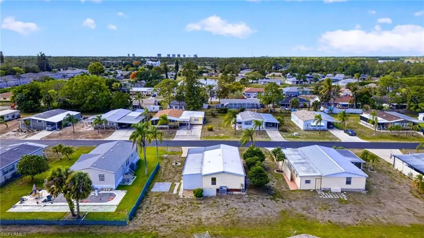 Aerial view showcasing a residential community with paved streets and established homes