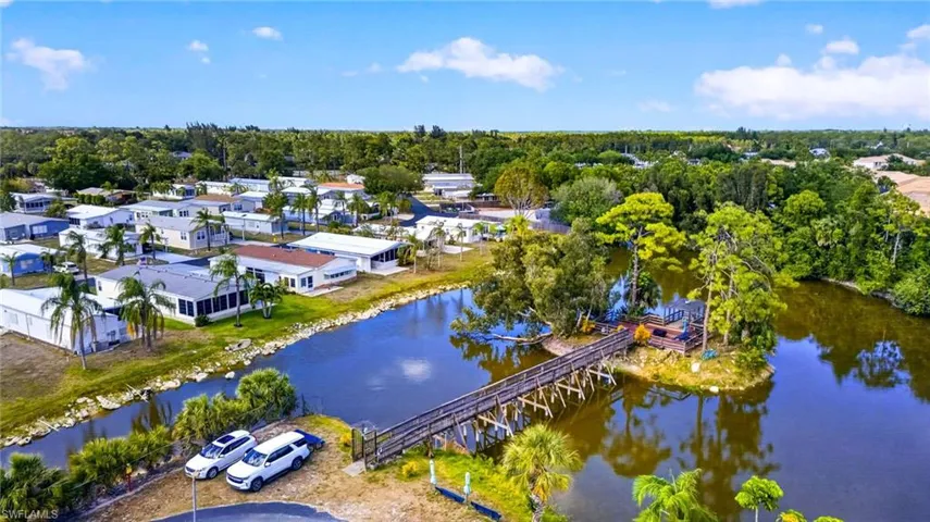 Aerial view of the property's surroundings, featuring a serene waterway and lush greenery