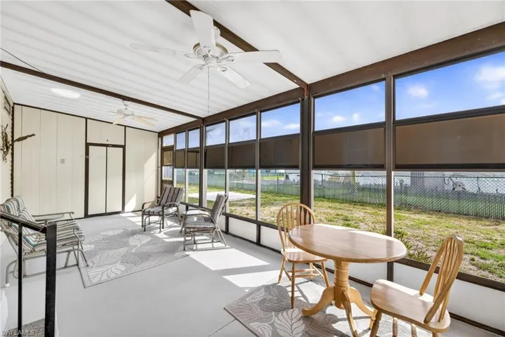 The property features a sunroom with large windows, providing abundant natural light and views of the surrounding area