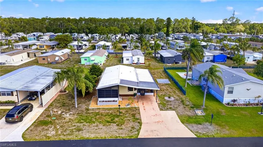 The property features a paved driveway and an attached carport