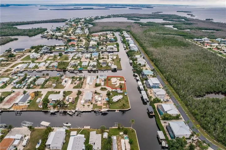 Birds eye view of property with a water view