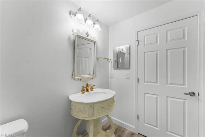 Bathroom featuring toilet and light wood-type flooring