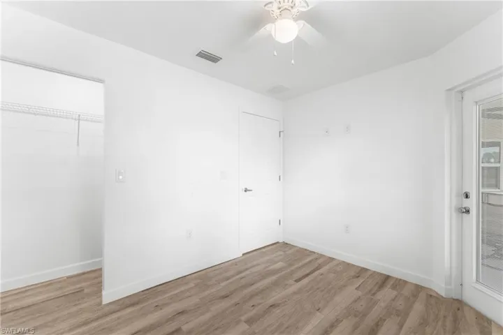 Unfurnished bedroom featuring light wood-style floors and ceiling fan
