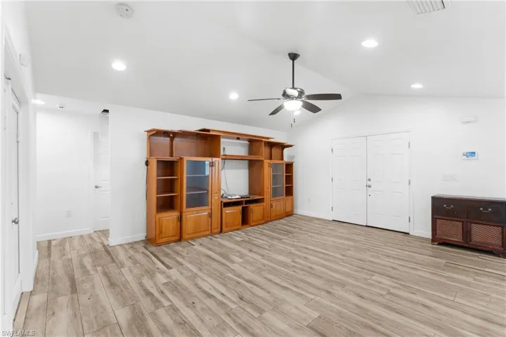Unfurnished living room featuring light wood-style flooring, a ceiling fan, and recessed lighting